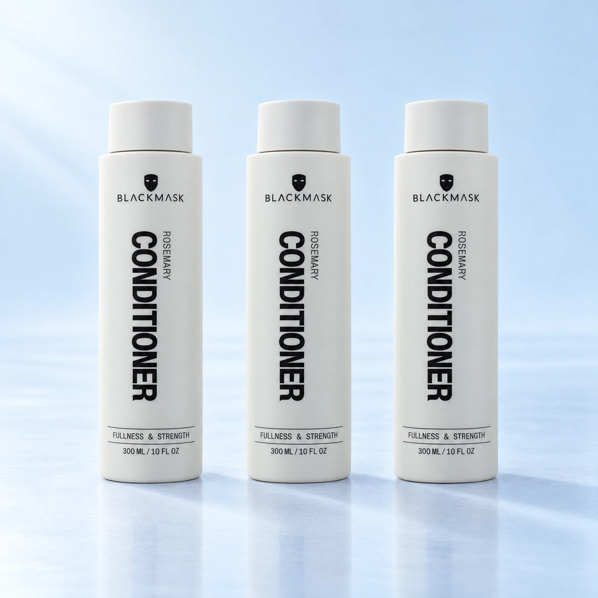 BLACKMASK conditioner three pack on a pale blue studio background