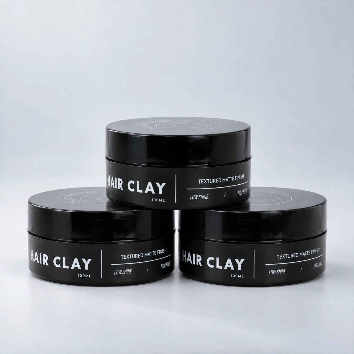 BLACKMASK Hair Clay three-pack on a cool grey studio background